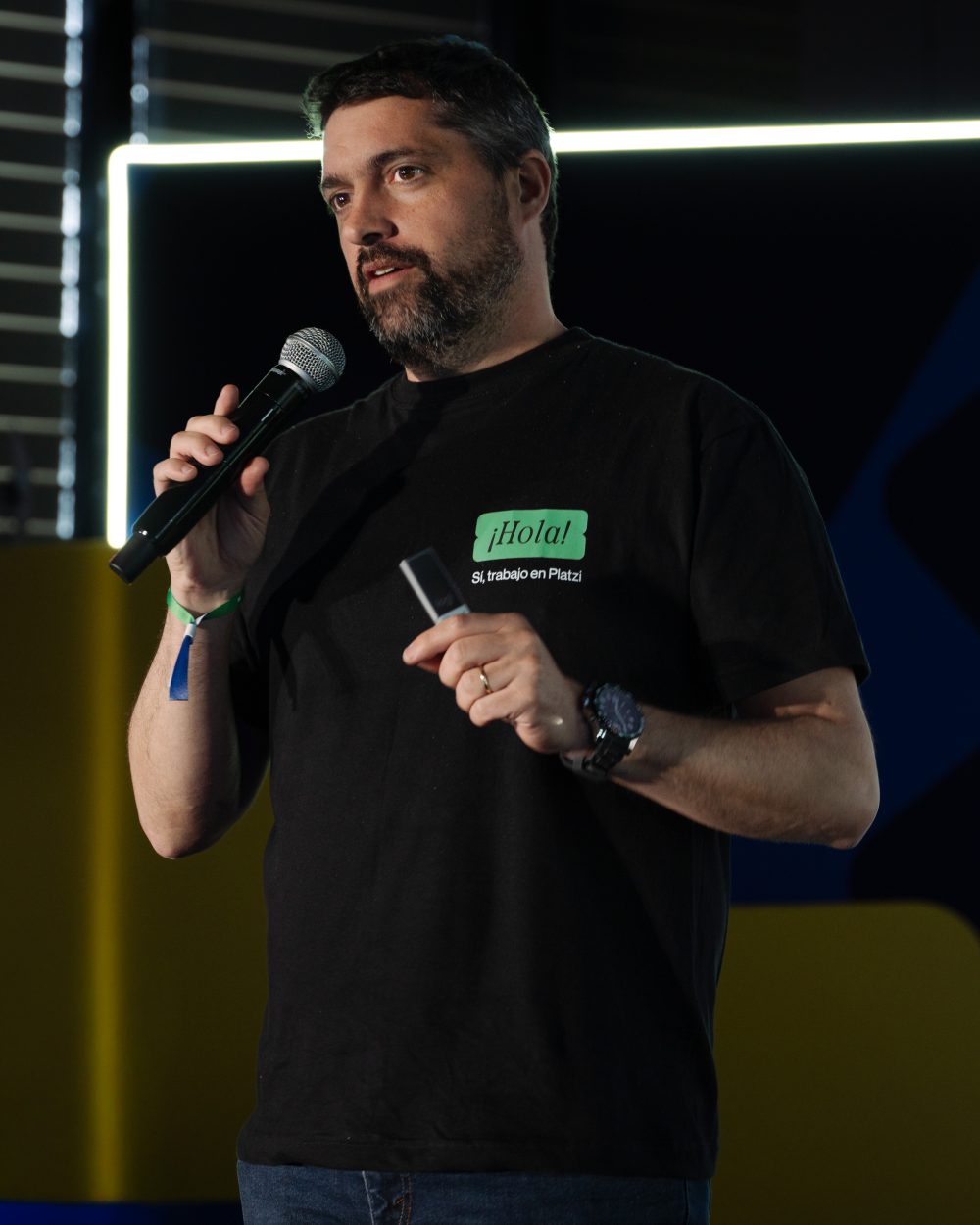 Javi speaking on stage, microphone in hand